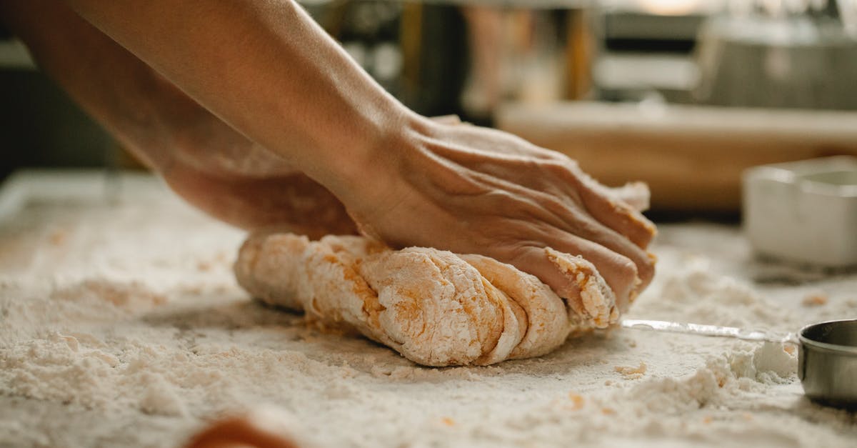 How to prepare pie dough in bulk at home? - Unrecognizable woman kneading soft egg dough on table covered with flour in kitchen How to prepare pie dough in bulk at home? - Unrecognizable woman kneading soft egg dough on table covered with flour in kitchen