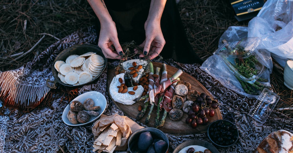 How to prepare this (Chinese) snack? - From above crop anonymous female serving yummy food including asparagus with bacon potatoes and grapes on wooden board placed on plaid during picnic in nature How to prepare this (Chinese) snack? - From above crop anonymous female serving yummy food including asparagus with bacon potatoes and grapes on wooden board placed on plaid during picnic in nature