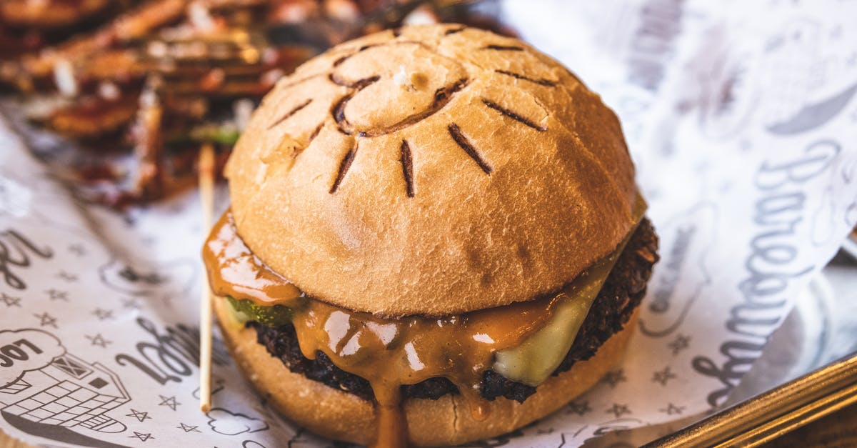 How to prevent bursting from cheese stuffed beef patties? - Delicious hamburger with cutlet and cheese on wooden table How to prevent bursting from cheese stuffed beef patties? - Delicious hamburger with cutlet and cheese on wooden table