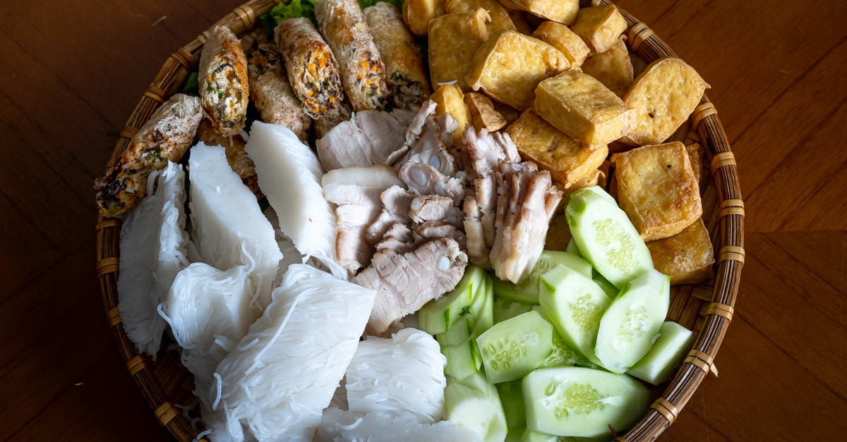 How to prevent my wide rice noodles from breaking after cooked? - Top view of Asian food with rice noodles cucumber fried tofu and boiled pork with springs rolls served in bowl on table How to prevent my wide rice noodles from breaking after cooked? - Top view of Asian food with rice noodles cucumber fried tofu and boiled pork with springs rolls served in bowl on table