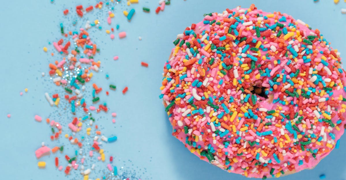 How to prevent sweet thick glaze/sauce from setting after cooling? - Colorful donut with sprinkles on blue surface