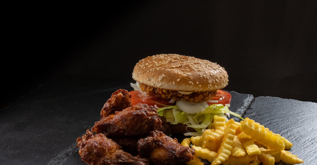 How to prevent the breading residue sticking in chicken fry? - Chicken burger with chicken wings and french fries How to prevent the breading residue sticking in chicken fry? - Chicken burger with chicken wings and french fries