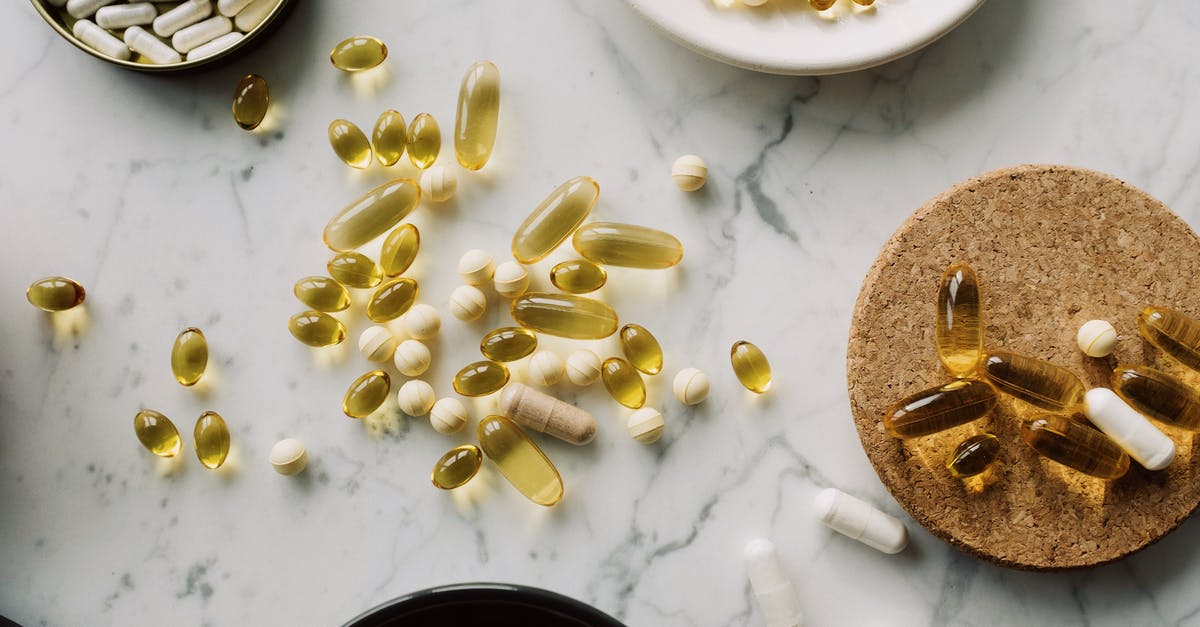 How to prevent the silver utensils from tarnishing? - Top view of various pills and vitamins placed in diverse utensil on marble board