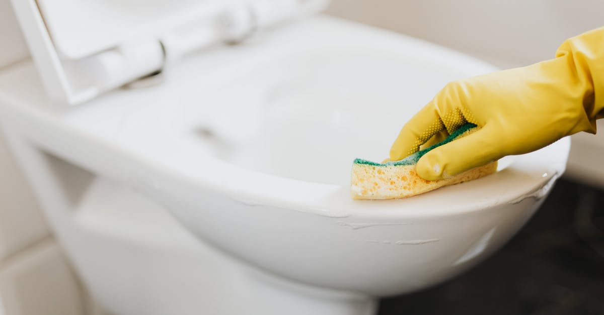 How to properly disinfect surfaces - Crop person in rubber glove cleaning toilet bowl How to properly disinfect surfaces - Crop person in rubber glove cleaning toilet bowl