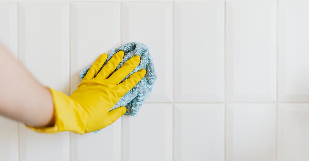How to properly disinfect surfaces - Crop person cleaning tiles with rag How to properly disinfect surfaces - Crop person cleaning tiles with rag