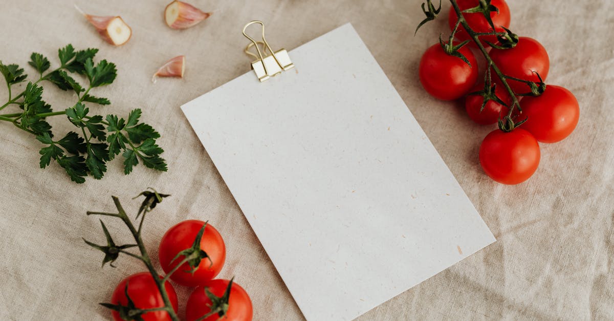 How to properly slow cook lamb's head? - Top view of blank clipboard with golden paper binder placed on linen tablecloth among tasty red tomatoes on branches together with chopped garlic head and green parsley ideal for recipe or menu How to properly slow cook lamb's head? - Top view of blank clipboard with golden paper binder placed on linen tablecloth among tasty red tomatoes on branches together with chopped garlic head and green parsley ideal for recipe or menu
