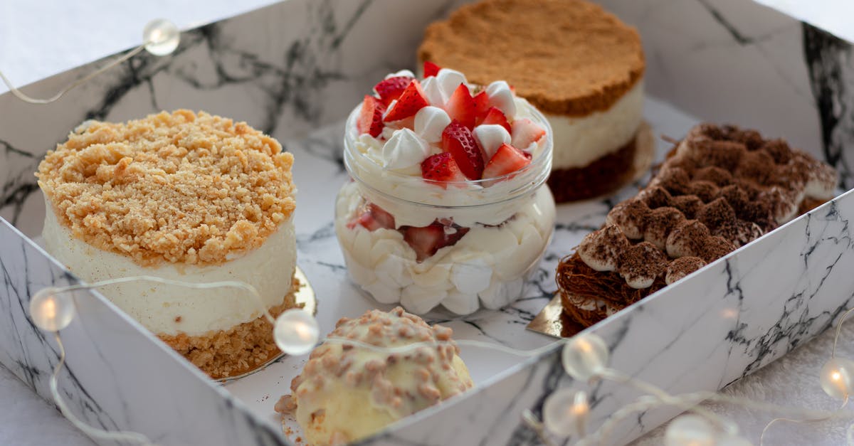 How to protect honey jar from ants? - From above of delicious sweet cupcakes including creamy parfait with strawberry and round honey cake and napoleon cake near plate with tiramisu and cupcake covered with white chocolate placed in white box How to protect honey jar from ants? - From above of delicious sweet cupcakes including creamy parfait with strawberry and round honey cake and napoleon cake near plate with tiramisu and cupcake covered with white chocolate placed in white box