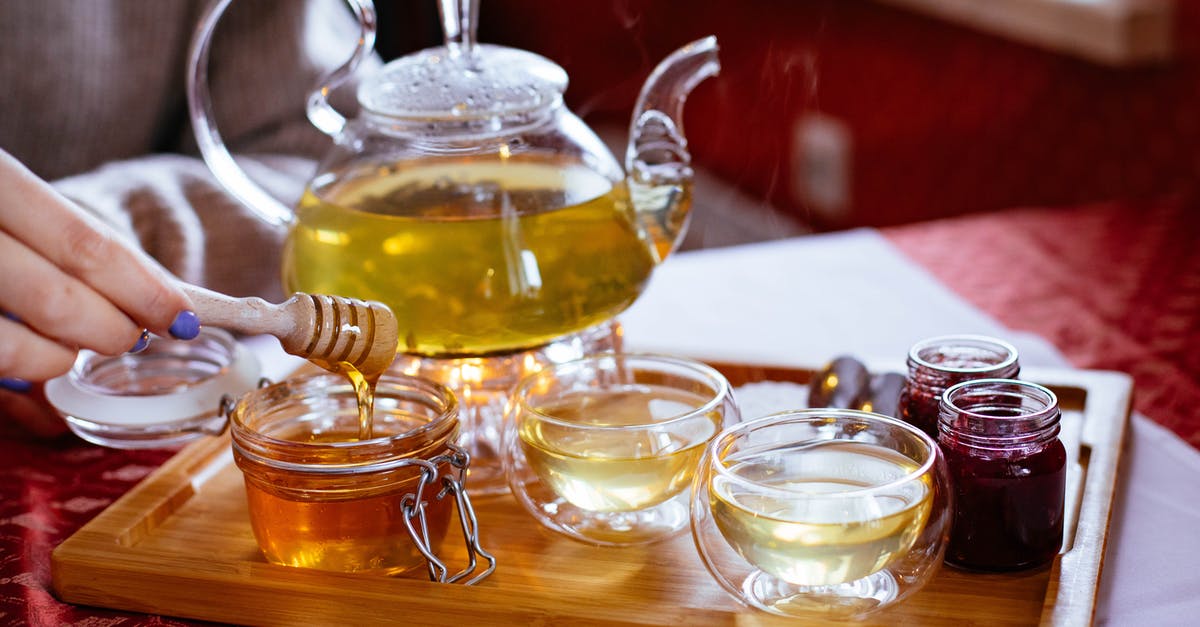 How to protect honey jar from ants? - Person Holding Honey Stick With Teapot How to protect honey jar from ants? - Person Holding Honey Stick With Teapot