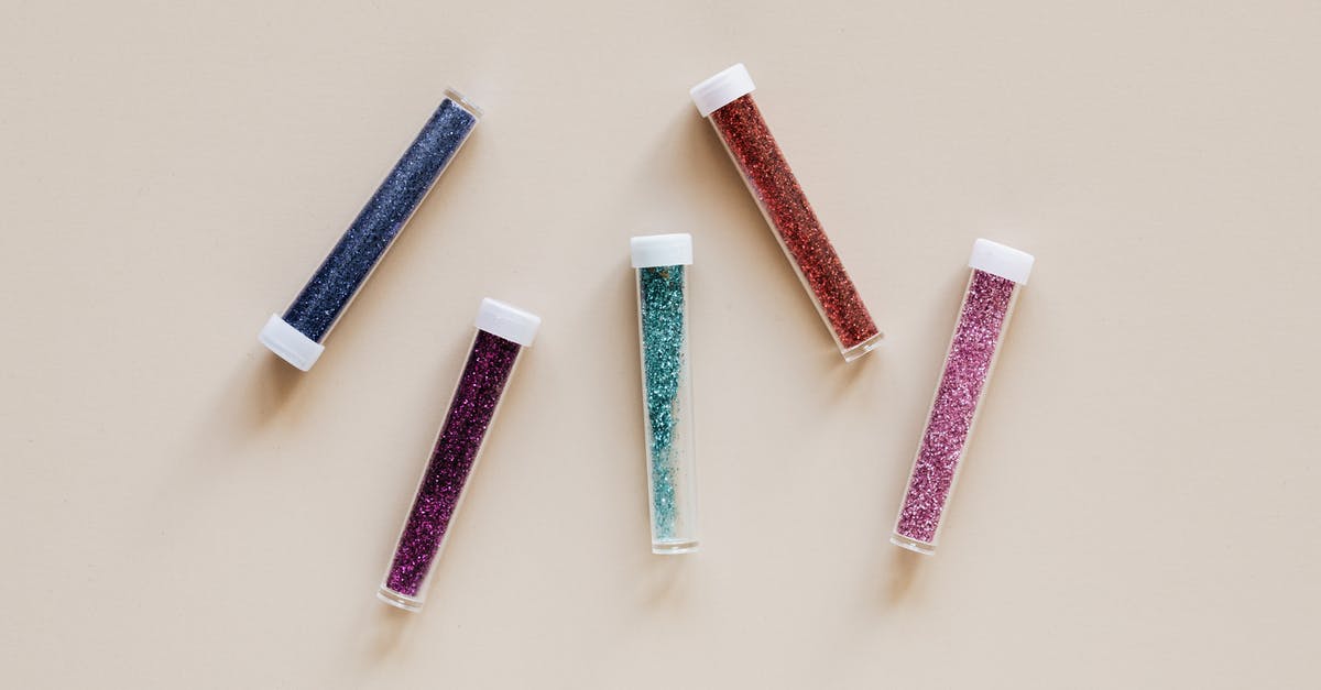 How to quickly fill cannelloni tubes with relatively dry mixture [duplicate] - From above of  plastic transparent containers with multicolored powder placed randomly on beige surface