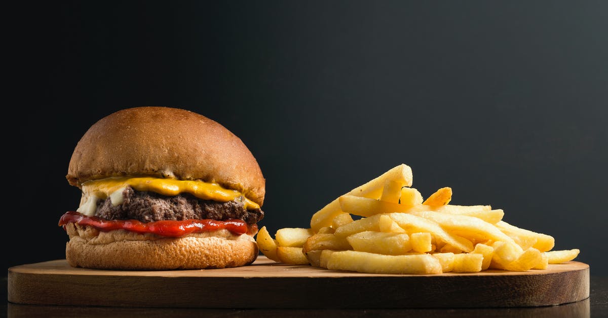 How to recreate the sauce in McDonald's 1955 Burger? - Appetizing burger with meat patty ketchup and cheese placed on wooden table with crispy french fries against black background How to recreate the sauce in McDonald's 1955 Burger? - Appetizing burger with meat patty ketchup and cheese placed on wooden table with crispy french fries against black background