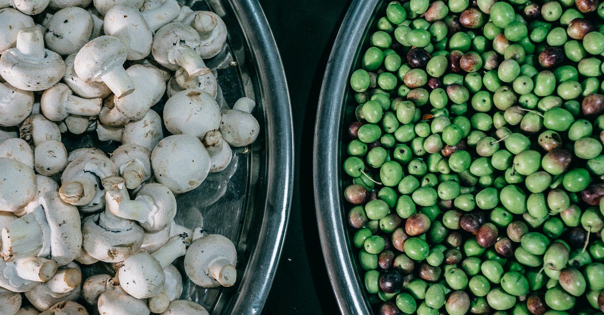 How to reduce Phytate in pea protein isolate? - Top view composition of ripe raw green peas and fresh mushrooms heaped in steel bowls and placed on dark table How to reduce Phytate in pea protein isolate? - Top view composition of ripe raw green peas and fresh mushrooms heaped in steel bowls and placed on dark table