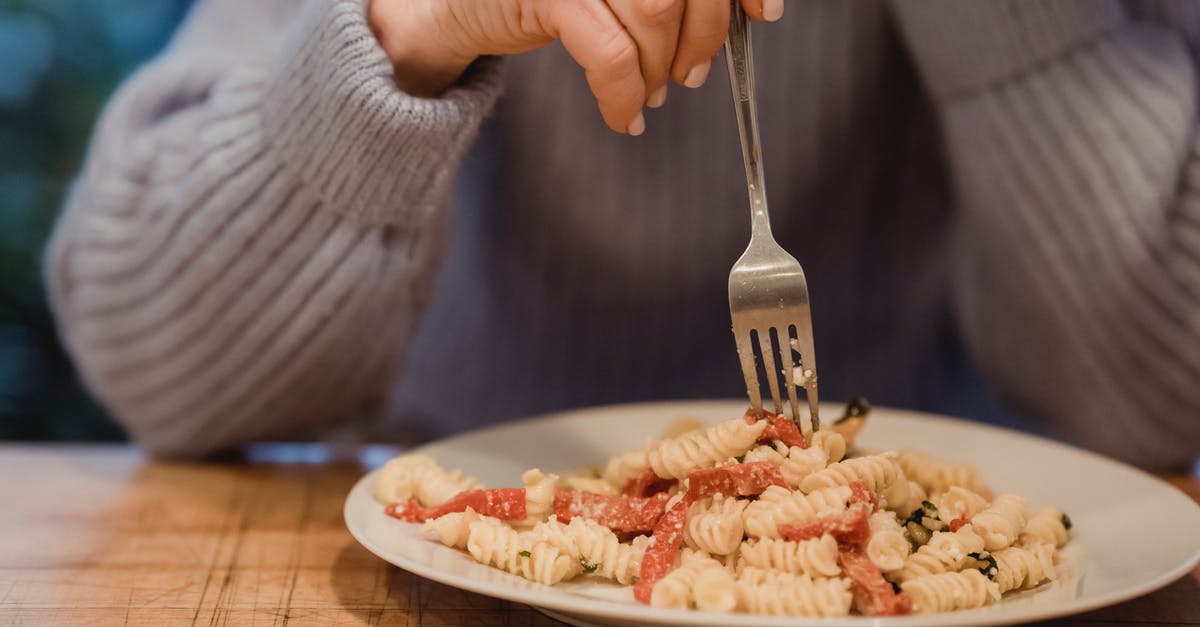 How to reduce the bitter taste in broccoli rabe - Crop faceless female wearing blue sweater enjoying delicious fusilli pasta with tomatoes and broccoli served on white plate How to reduce the bitter taste in broccoli rabe - Crop faceless female wearing blue sweater enjoying delicious fusilli pasta with tomatoes and broccoli served on white plate