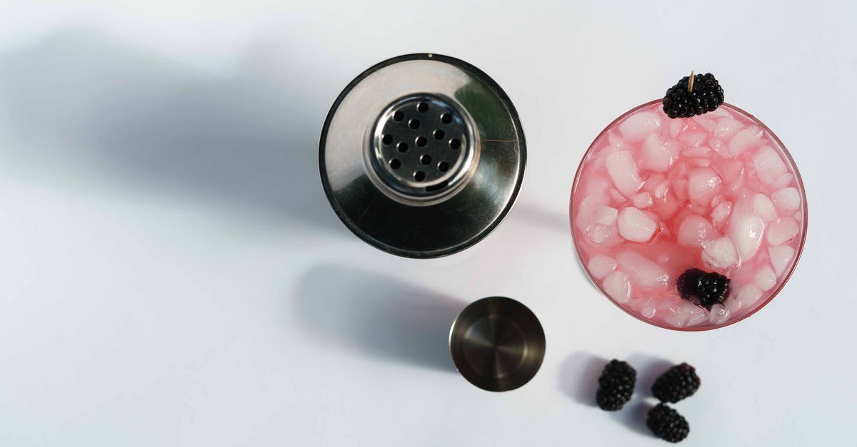How to refresh a frozen bagel - Top view of glass of cold blackberry margarita with berries and ice cubes near stainless shaker on white background How to refresh a frozen bagel - Top view of glass of cold blackberry margarita with berries and ice cubes near stainless shaker on white background