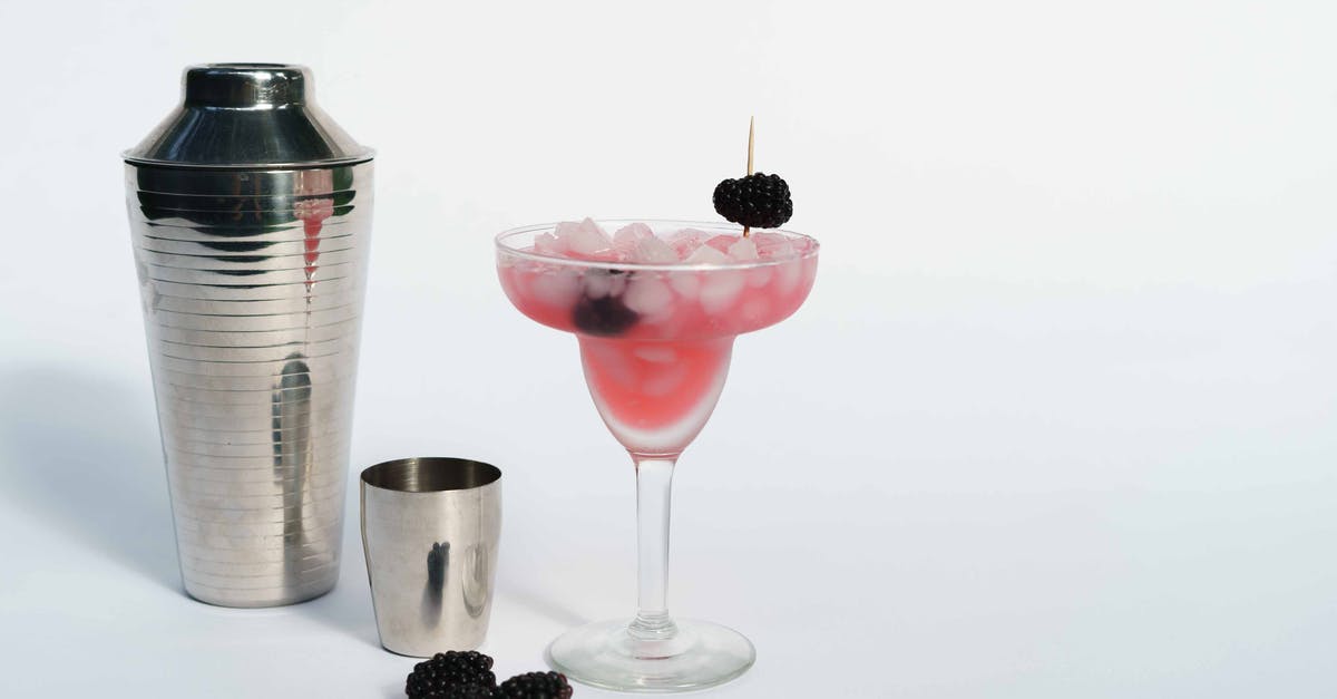 How to refresh a frozen bagel - Cold refreshing margarita cocktail made of ice cubes and blackberries placed near shaker on white background How to refresh a frozen bagel - Cold refreshing margarita cocktail made of ice cubes and blackberries placed near shaker on white background