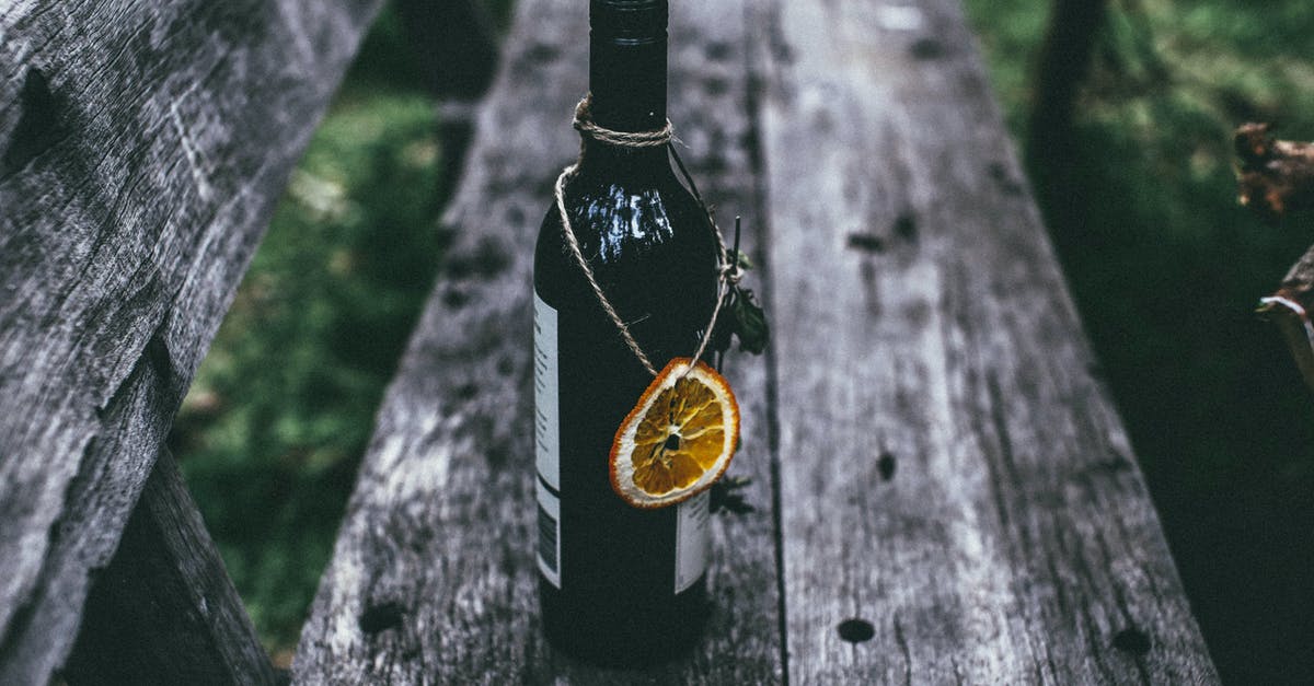 How to remove alcohol taste from vanilla extract? - From above of glass bottle of wine with dried orange placed on old wooden bench in nature in daytime How to remove alcohol taste from vanilla extract? - From above of glass bottle of wine with dried orange placed on old wooden bench in nature in daytime