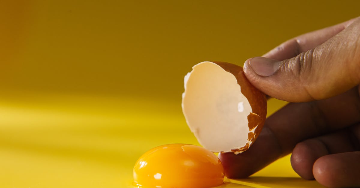 How to remove bits of egg shell from a cracked egg? - Person Holding White Heart Shaped Ornament How to remove bits of egg shell from a cracked egg? - Person Holding White Heart Shaped Ornament