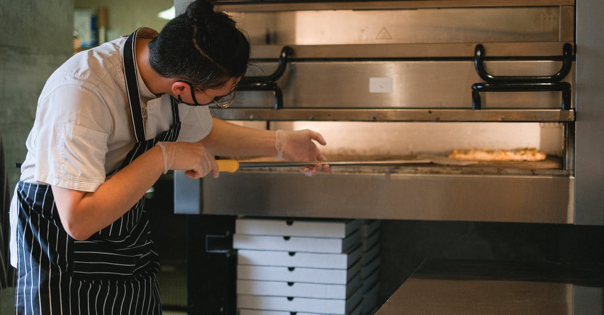 How to remove pizza pan from oven without a peel? - A Man Putting a Pizza in the Oven with a Pizza Peel How to remove pizza pan from oven without a peel? - A Man Putting a Pizza in the Oven with a Pizza Peel