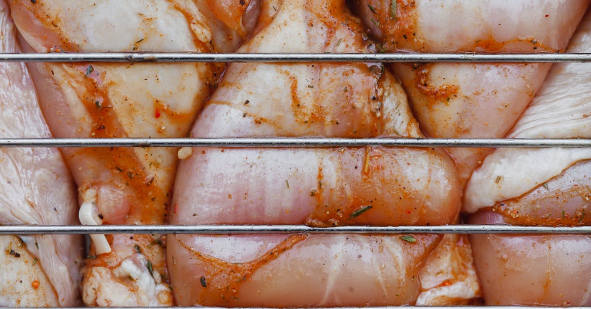 How to remove that raw chicken taste while cooking chicken? - From above of closeup of raw chicken legs with seasoning cooking on metal grill grate How to remove that raw chicken taste while cooking chicken? - From above of closeup of raw chicken legs with seasoning cooking on metal grill grate
