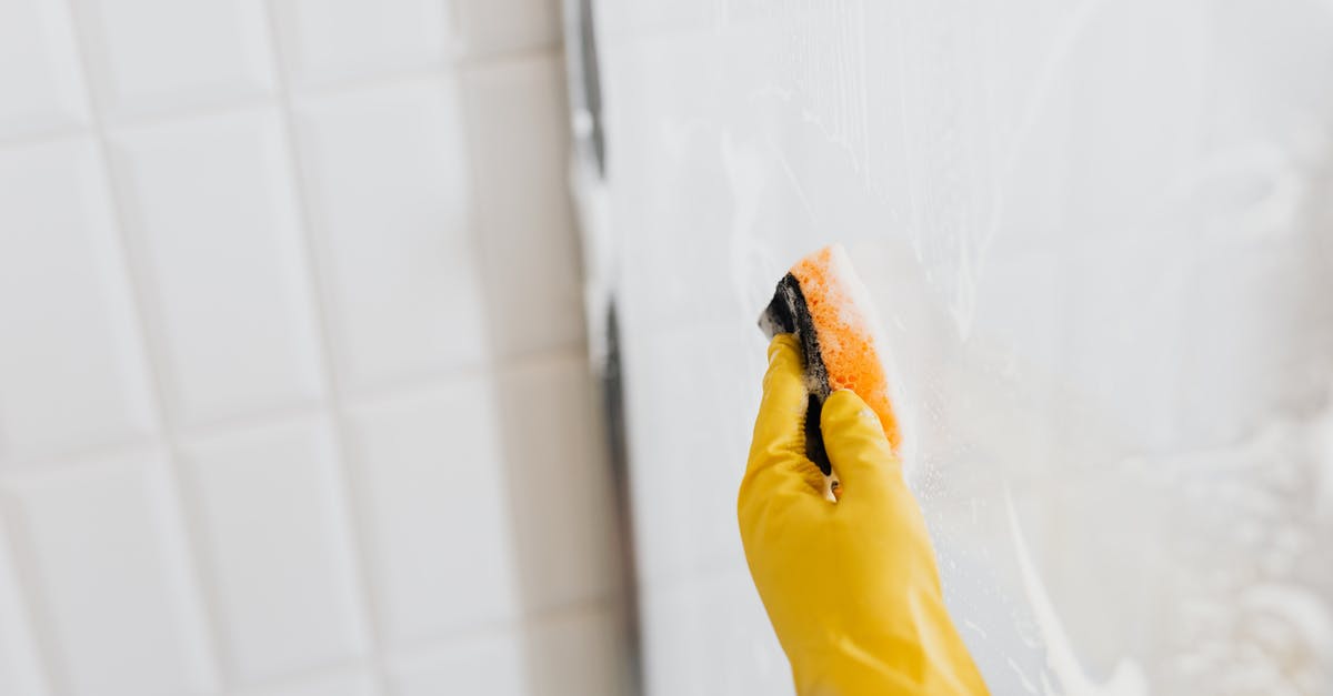 How to remove the excessive saltiness from gammon? - From above of crop anonymous person in yellow rubber protective glove washing shower cabin glass with sponge and detergent How to remove the excessive saltiness from gammon? - From above of crop anonymous person in yellow rubber protective glove washing shower cabin glass with sponge and detergent