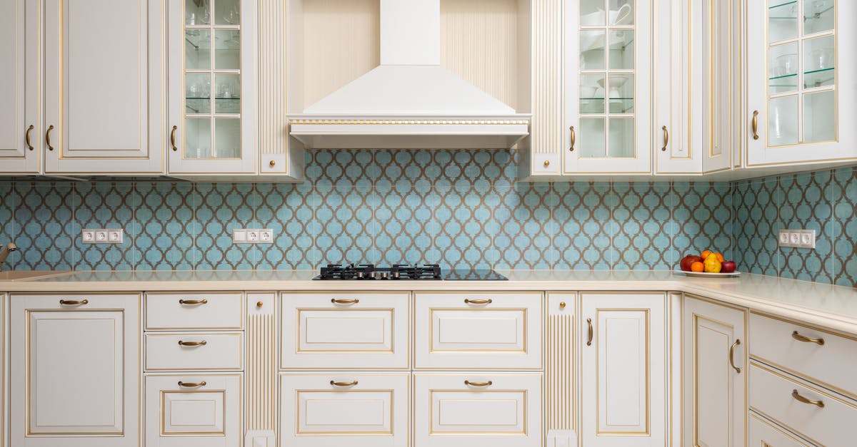 How to remove white stain after stove cleaning? - Interior of light modern kitchen with wooden white cabinets and blue tile backsplash with classic hood How to remove white stain after stove cleaning? - Interior of light modern kitchen with wooden white cabinets and blue tile backsplash with classic hood
