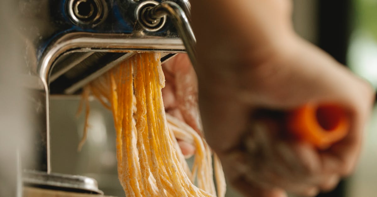 How to safely handle raw milk? - Crop person cutting dough with pasta machine How to safely handle raw milk? - Crop person cutting dough with pasta machine