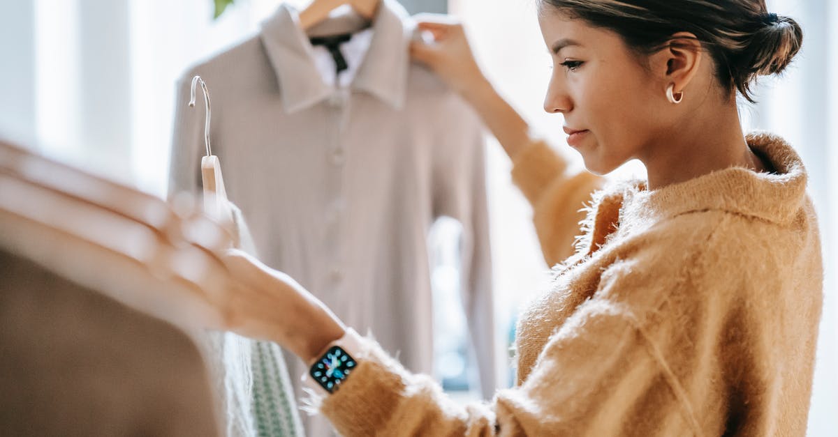 How to select a drain rack for pots and pans? - Crop focused ethnic female in casual clothes choosing apparel while standing near rack in boutique How to select a drain rack for pots and pans? - Crop focused ethnic female in casual clothes choosing apparel while standing near rack in boutique