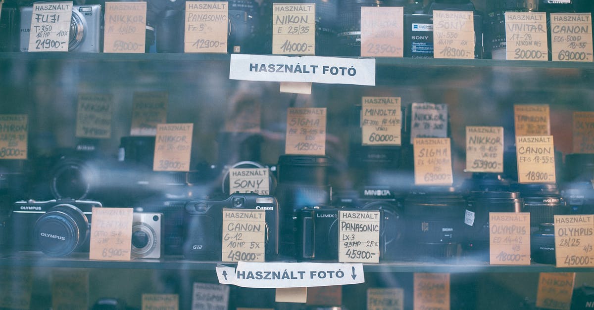 How to select a good non-stick pan, price point wise? - Through glass collection of various photo cameras placed on local store showcase with paper price label and inscriptions How to select a good non-stick pan, price point wise? - Through glass collection of various photo cameras placed on local store showcase with paper price label and inscriptions