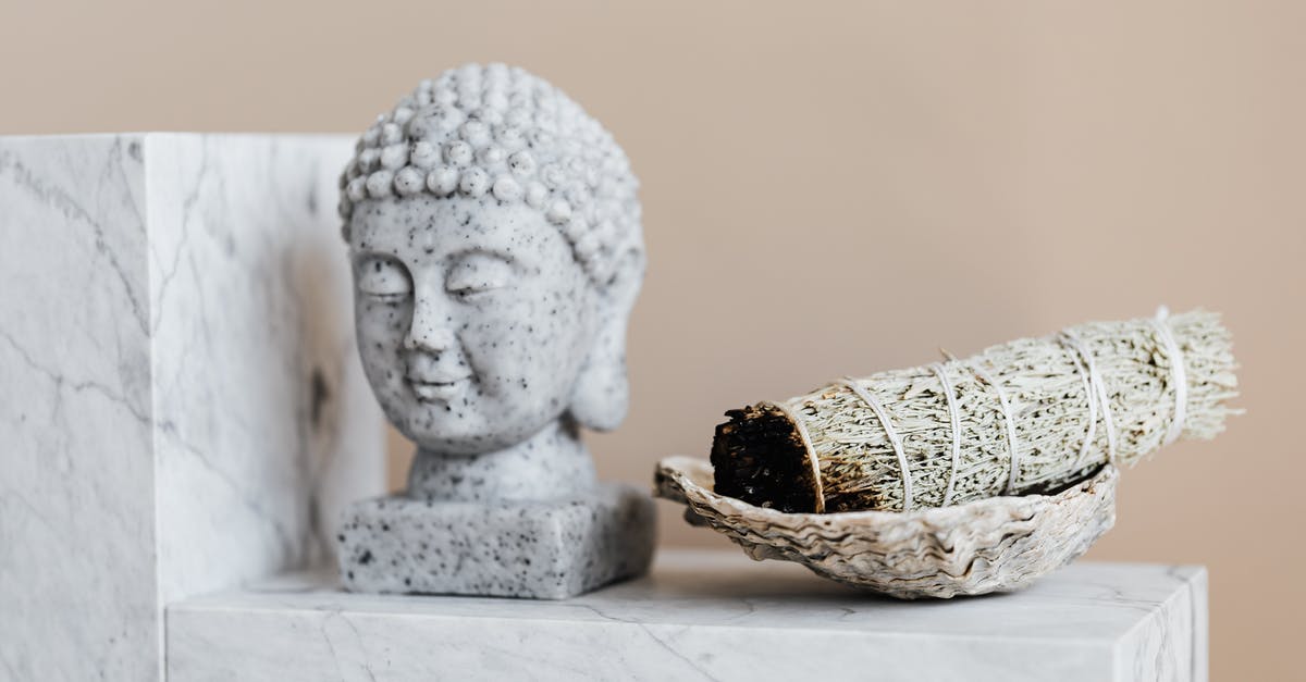 How to shape the perfect bao dough - Bust of Buddha and dry sage bundle on marble surface