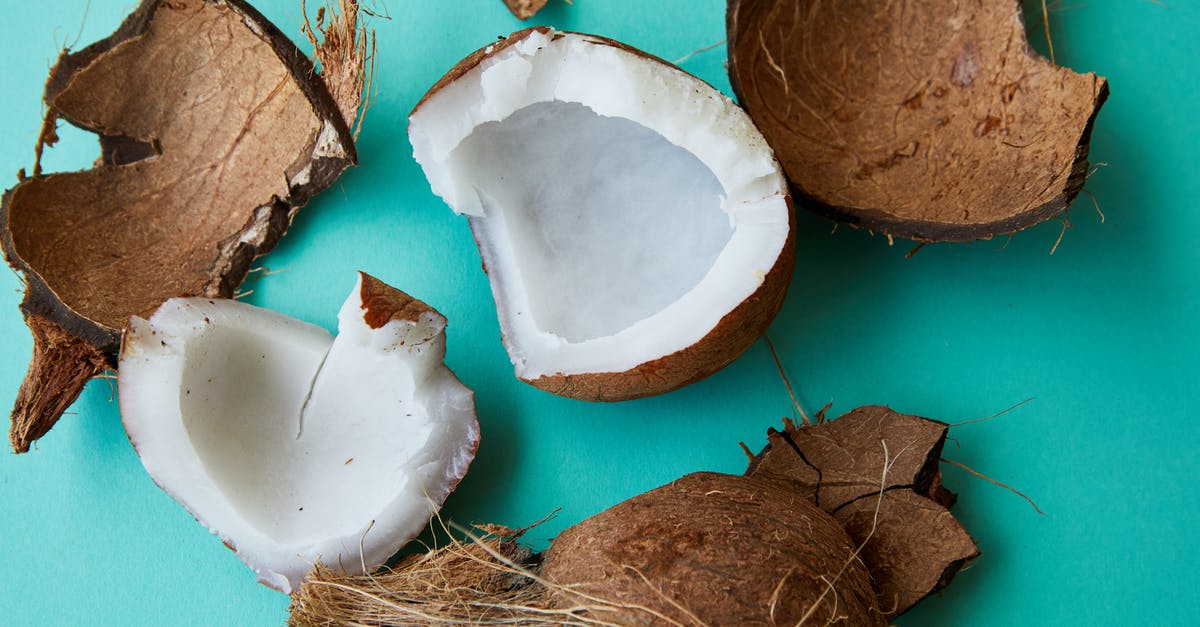 How to shell a coconut without breaking the seed? - Pieces of cracked coconut with aromatic white pulp How to shell a coconut without breaking the seed? - Pieces of cracked coconut with aromatic white pulp