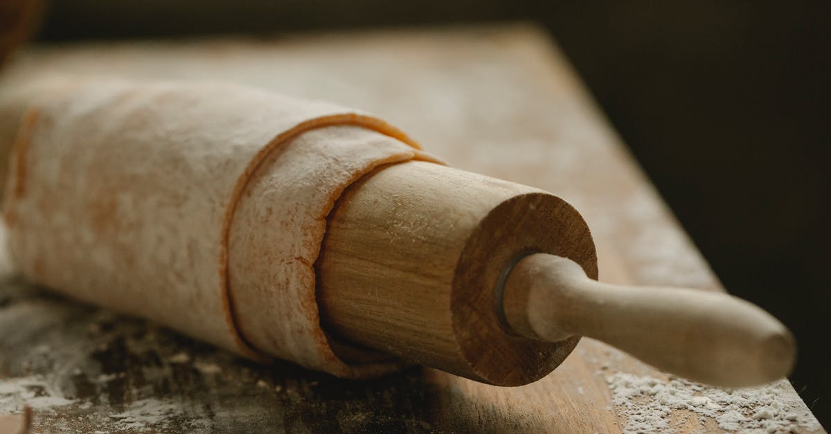 How to smooth a wooden rolling pin - Rolling pin with dough on messy table How to smooth a wooden rolling pin - Rolling pin with dough on messy table