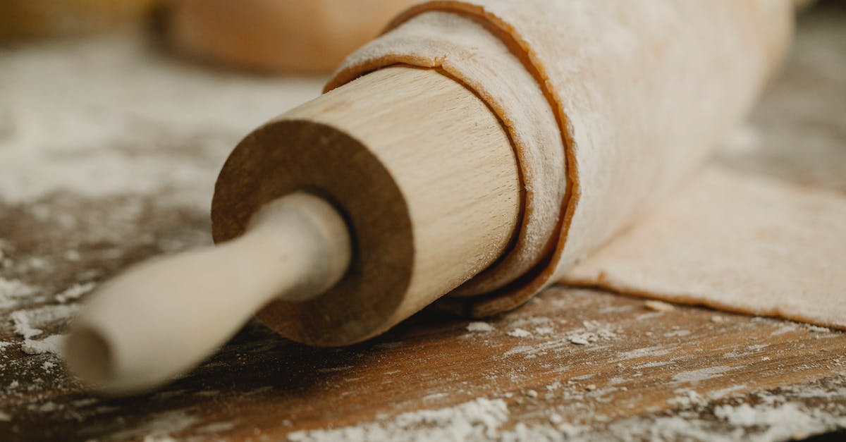 How to smooth a wooden rolling pin - Thin dough on rolling pin on messy table How to smooth a wooden rolling pin - Thin dough on rolling pin on messy table