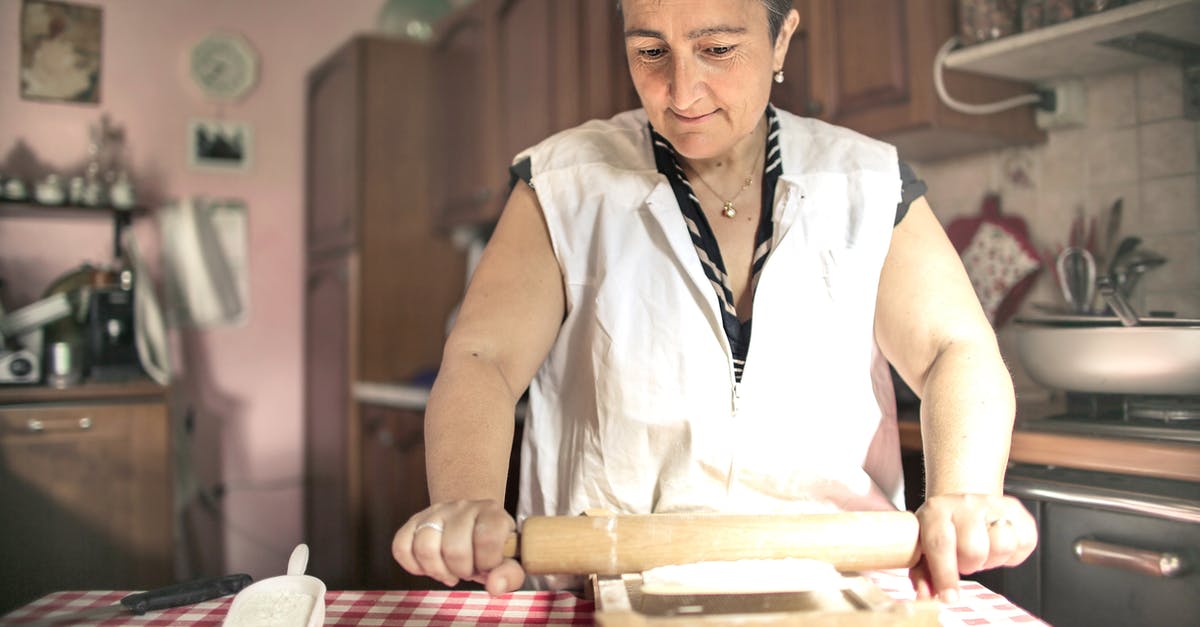 How to smooth a wooden rolling pin - Aged female baker rolling gough with pin while cooking in cozy kitchen at home How to smooth a wooden rolling pin - Aged female baker rolling gough with pin while cooking in cozy kitchen at home