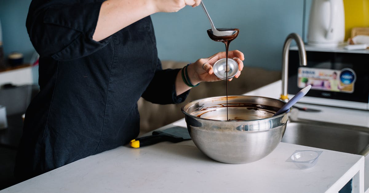 How to solidify melted chocolate? - A Person Scooping Melted Chocolate From a Stainless Bowl How to solidify melted chocolate? - A Person Scooping Melted Chocolate From a Stainless Bowl