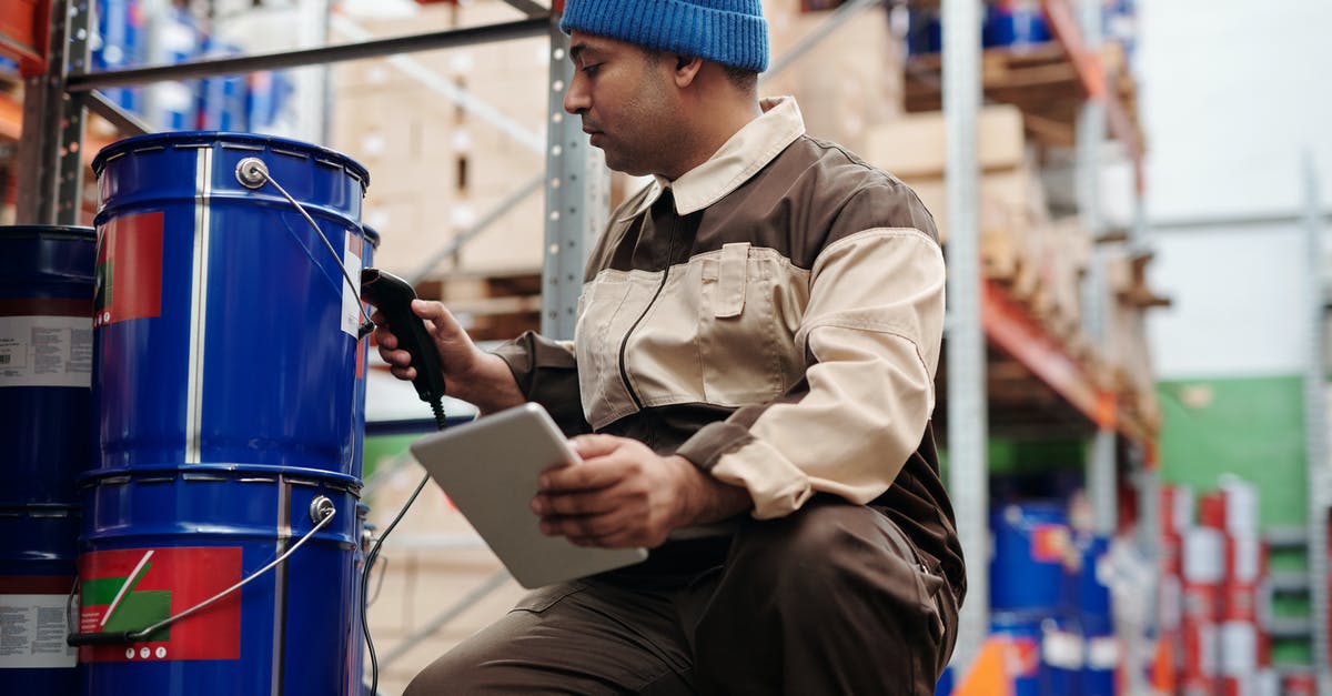 How to store a 5 gallon bucket of pickle slices? - Photo of Man Scanning a Bucket