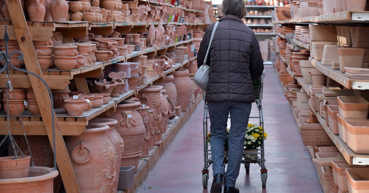 How to store clay dishes? - Back View of a Woman Looking at Ceramic Products in a Store How to store clay dishes? - Back View of a Woman Looking at Ceramic Products in a Store
