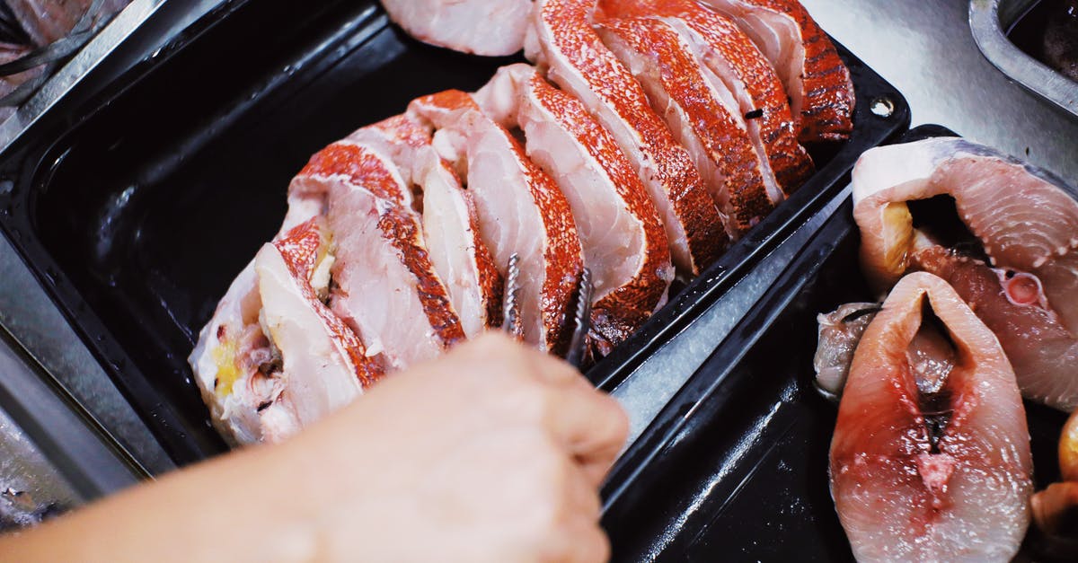 How to store smoked fish when traveling? - Person taking steak of fresh fish How to store smoked fish when traveling? - Person taking steak of fresh fish