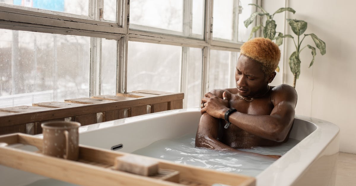 How to take care of a wooden mortar and pestle? - Young African American man with dyed hair and accessory sitting in bathtub full of water in light room with shabby window frames How to take care of a wooden mortar and pestle? - Young African American man with dyed hair and accessory sitting in bathtub full of water in light room with shabby window frames