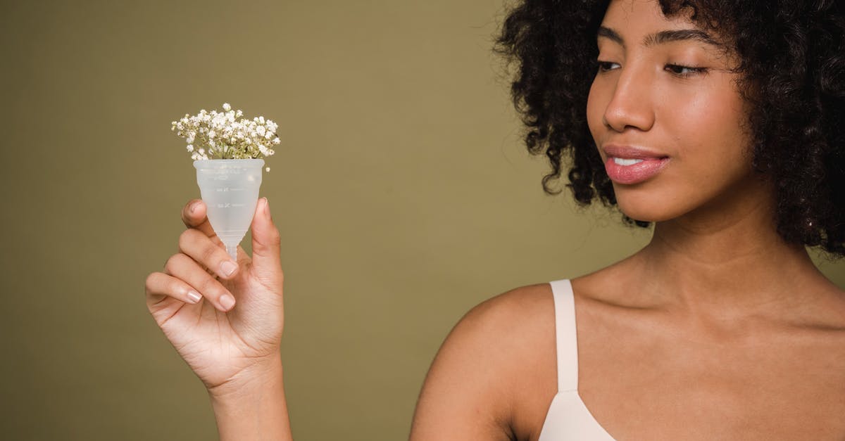 How to take care of Silicone cookware - Happy young African American female model with curly hair in bra smiling and showing menstrual cup with gentle flowers against beige background How to take care of Silicone cookware - Happy young African American female model with curly hair in bra smiling and showing menstrual cup with gentle flowers against beige background