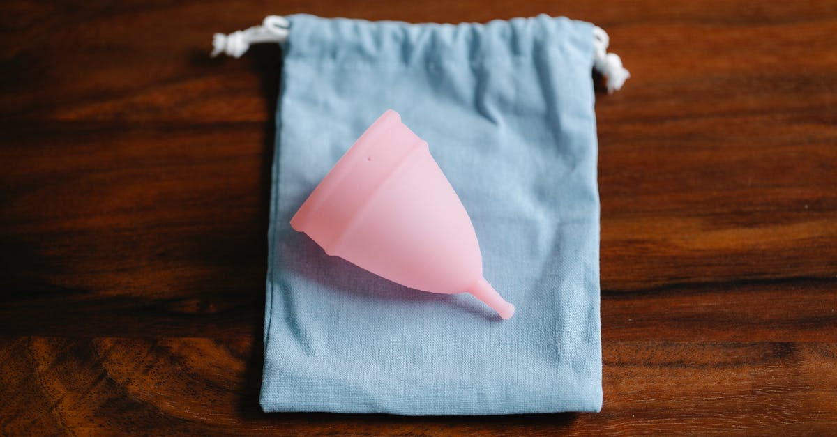 How to take care of Silicone cookware - Top view of pink menstrual cup for feminine hygienic procedure on cloth bag placed on wooden table in light room How to take care of Silicone cookware - Top view of pink menstrual cup for feminine hygienic procedure on cloth bag placed on wooden table in light room