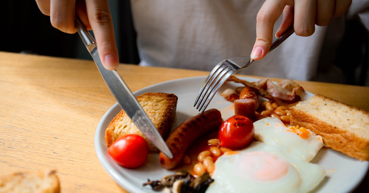 How to tell when bacon is cooked enough? - A Person Holding Silver Utensils How to tell when bacon is cooked enough? - A Person Holding Silver Utensils