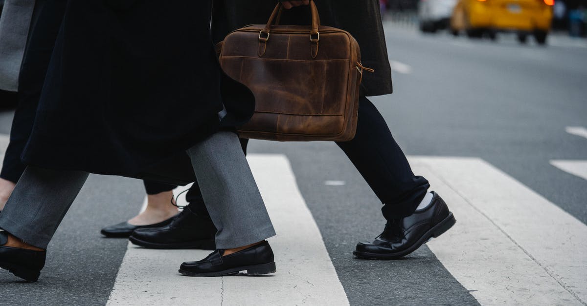 How to transport fresh ravioli to office potluck? - Side view of crop unrecognizable coworkers in formal wear with leather briefcase crossing urban road How to transport fresh ravioli to office potluck? - Side view of crop unrecognizable coworkers in formal wear with leather briefcase crossing urban road