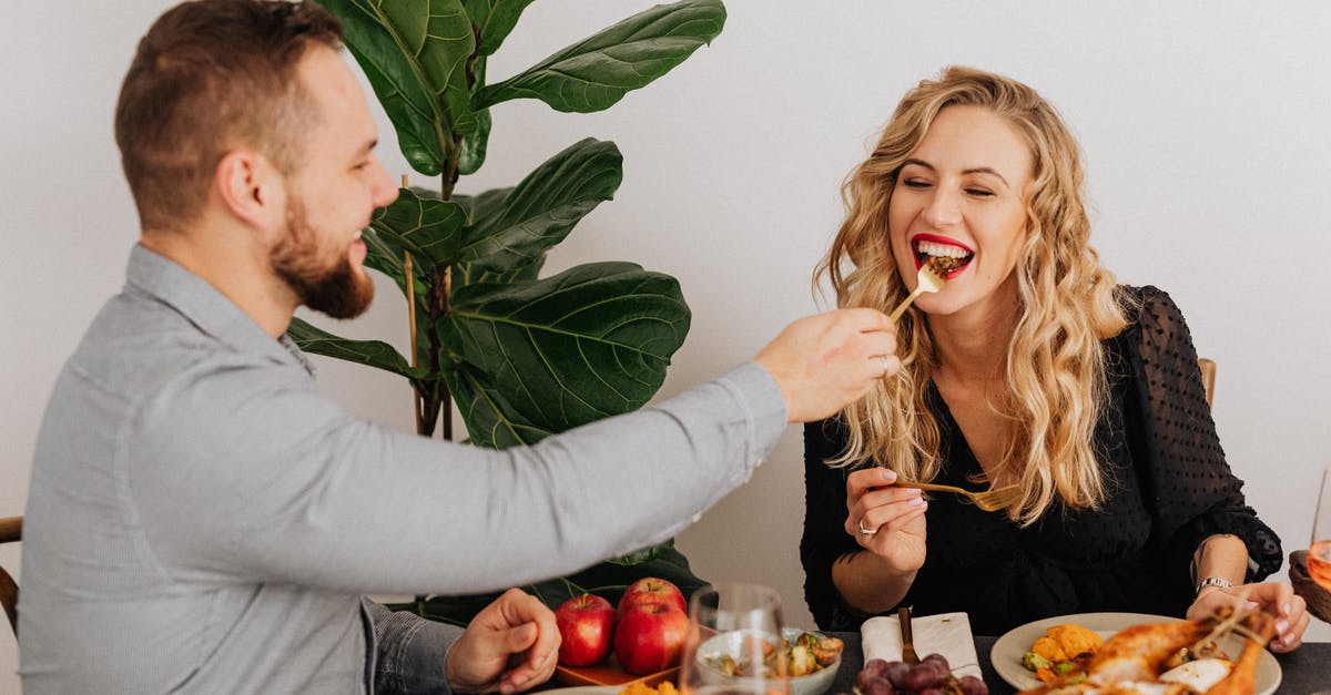 How to truss a chicken? - Woman in White Long Sleeve Shirt Smiling Beside Man in Gray Long Sleeve Shirt