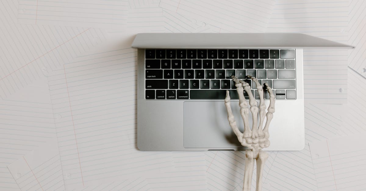 How to Use Frozen Bones for Bone Broth? - Overhead Shot of a Skeleton Hand Typing on a Laptop