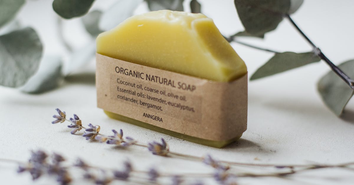 How to use herb extracts or essential oils in drinks - Organic natural soap made of essential oils placed near fresh flowers and branch of plant How to use herb extracts or essential oils in drinks - Organic natural soap made of essential oils placed near fresh flowers and branch of plant