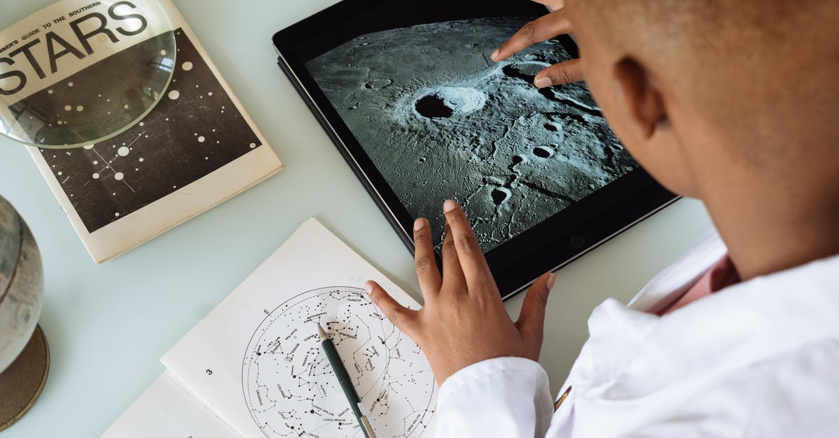 How to use stock from tablet - Crop African American student studying craters of moon on tablet at observatory How to use stock from tablet - Crop African American student studying craters of moon on tablet at observatory