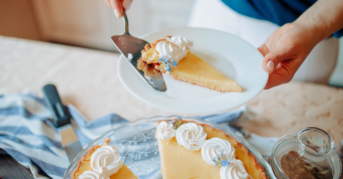 How to veganize and improve this cake recipe? - Anonymous woman with pie on plate near table in kitchen How to veganize and improve this cake recipe? - Anonymous woman with pie on plate near table in kitchen