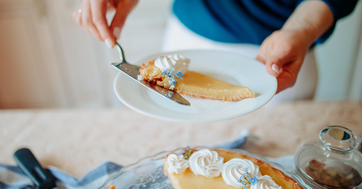 How to veganize and improve this cake recipe? - Anonymous woman with cake on plate near table in kitchen How to veganize and improve this cake recipe? - Anonymous woman with cake on plate near table in kitchen