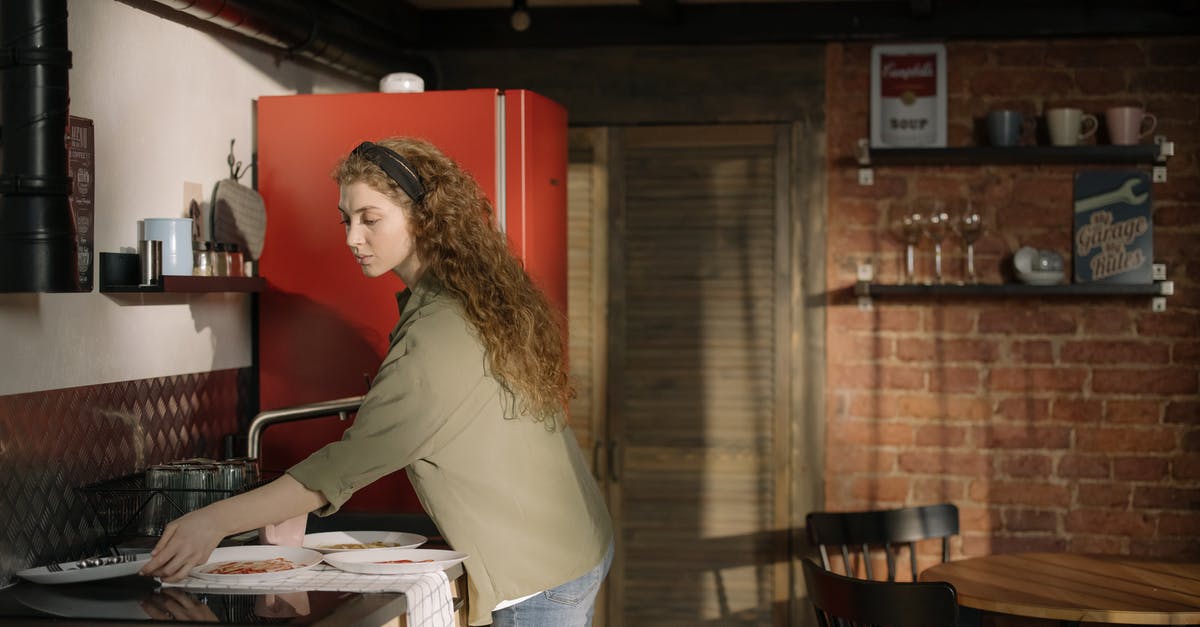 How to wash amaranth before cooking> - Woman in Gray Long Sleeve Shirt and Blue Denim Jeans Standing Beside Kitchen Counter How to wash amaranth before cooking> - Woman in Gray Long Sleeve Shirt and Blue Denim Jeans Standing Beside Kitchen Counter