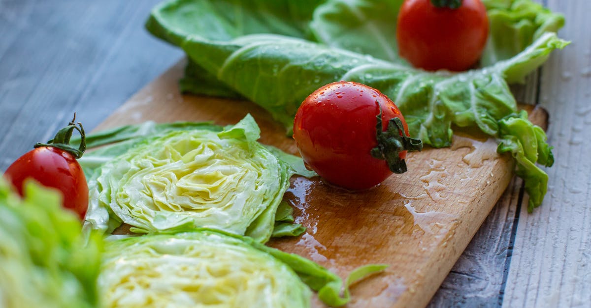 How to wash lettuce - From above of appetizing ripe red tomatoes and cut fresh cabbage placed on wet wooden chopping board in kitchen How to wash lettuce - From above of appetizing ripe red tomatoes and cut fresh cabbage placed on wet wooden chopping board in kitchen