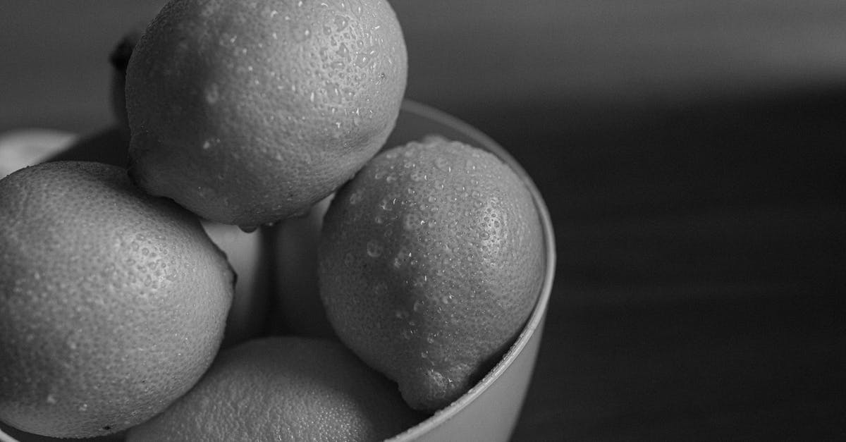 How to wash pesticides from fruit skins? - Pile of fresh wet lemons in bowl How to wash pesticides from fruit skins? - Pile of fresh wet lemons in bowl